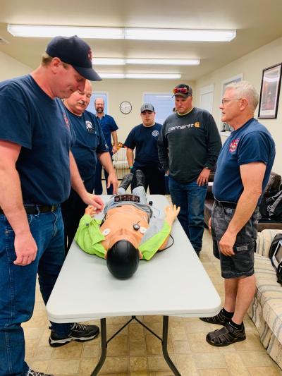 Medic demonstrating cpr on a training dummy